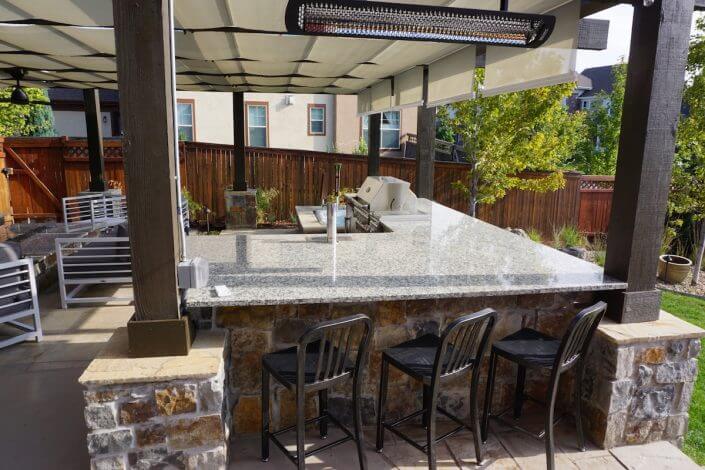 Hot tub with pergola outdoor kitchen paver patio fireplace hot tub lowry co