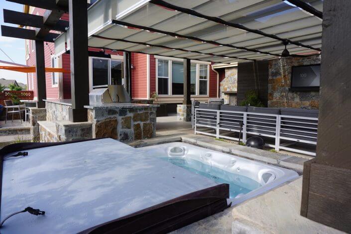 Hot tub with pergola outdoor kitchen paver patio fireplace hot tub lowry co